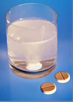 Pills, over the counter drugs, dissolving in a glass ofwater, photograph