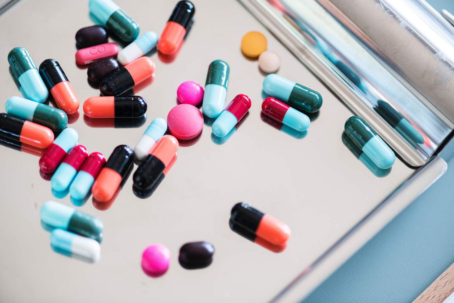 Image of capsules and tablets on a metal tray