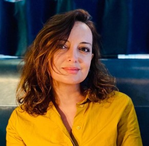 A head-and-shoulders photograph of Esmita Charani wearing a yellow shirt