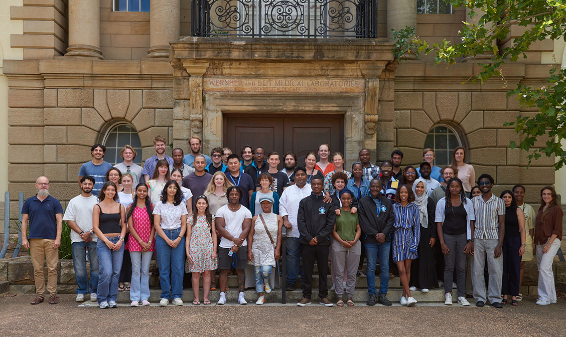 Group photo of all divisional members in front of medical school building