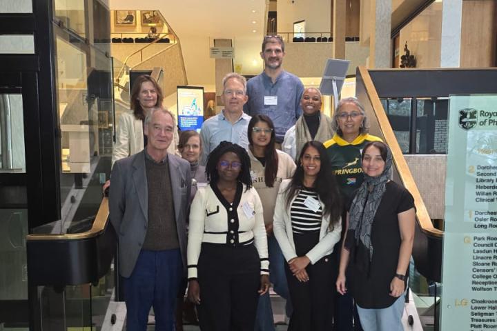 The CIDRI team standing on steps in the entrance foyer of the Royal College of Physicians