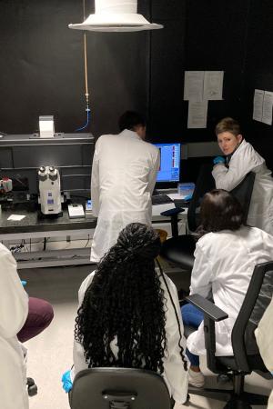 Workshop participants next to a widefield microscope