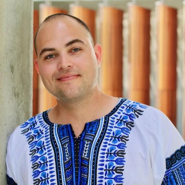 A head-and-shoulders photo of Dr Kurt Wibmer. He is wearing a blue-and white shirt.