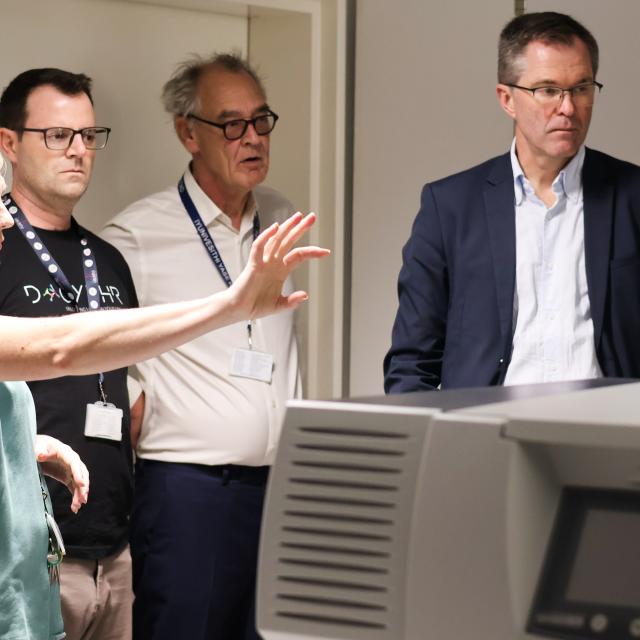 Caron Jacobs describing microscopy facilities to John-Arne Rottingen and Robert J Wilkinson
