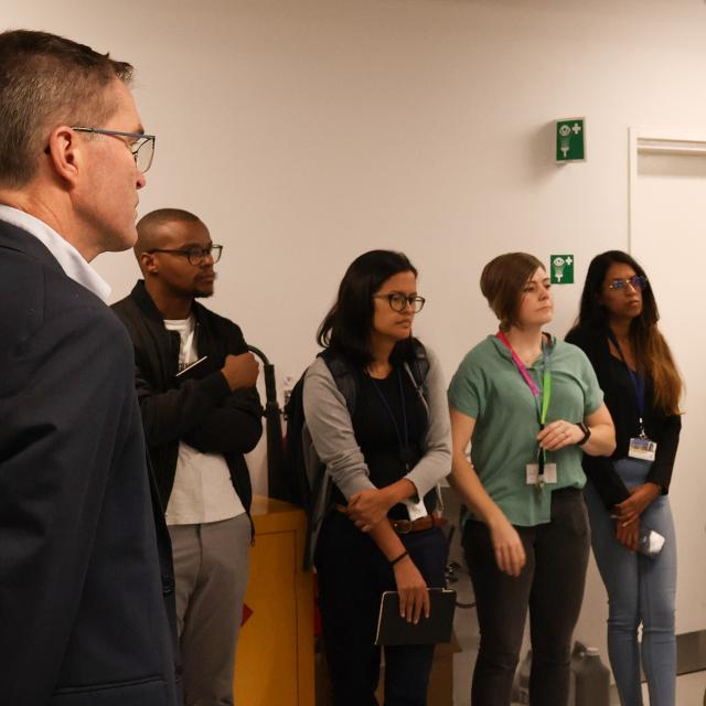 A group of people touring microscopy and laboratory facilities