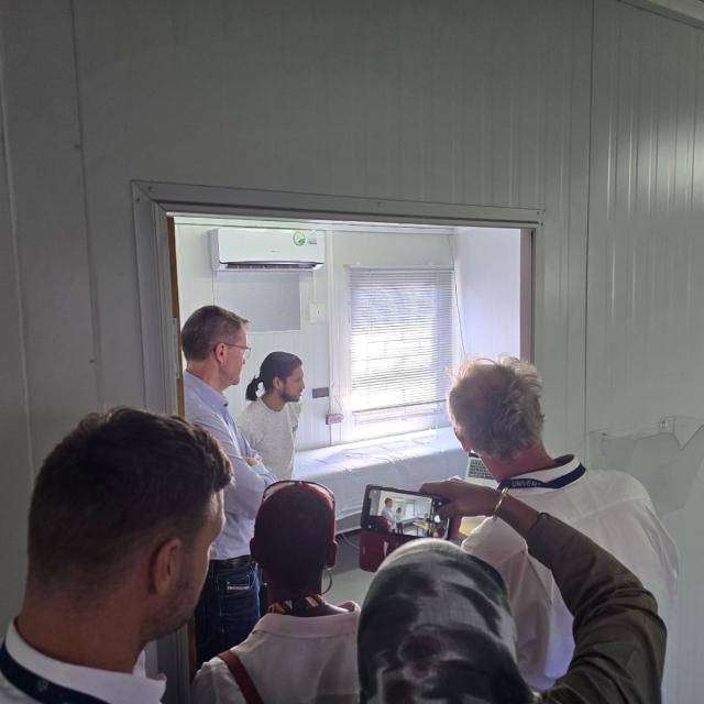 A group looking into a consulting room at a clinic