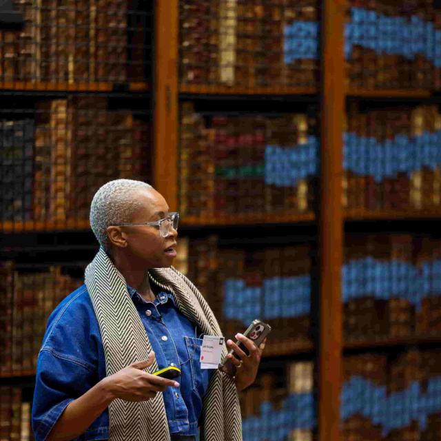 Prof. Molebogeng Rangaka speaks in a library