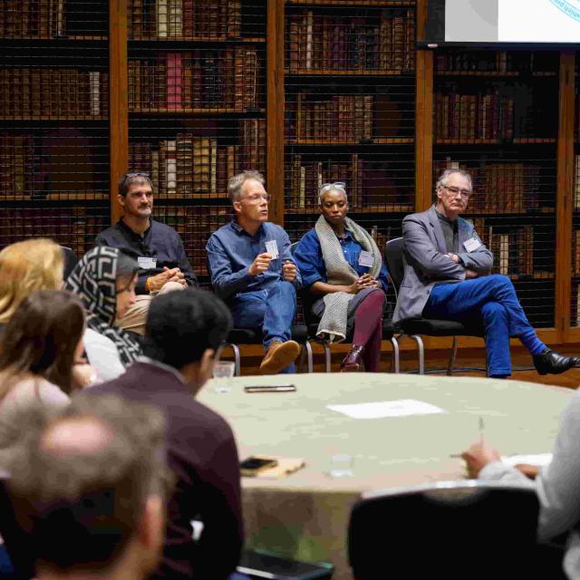 From left to right: Profs Boulle, Warner, Rangaka and Wilkinson form a panel addressing questions from the audience in a library